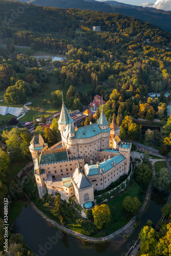 vertical drone view of Bojnice Castle in Slovakia in warm evening light