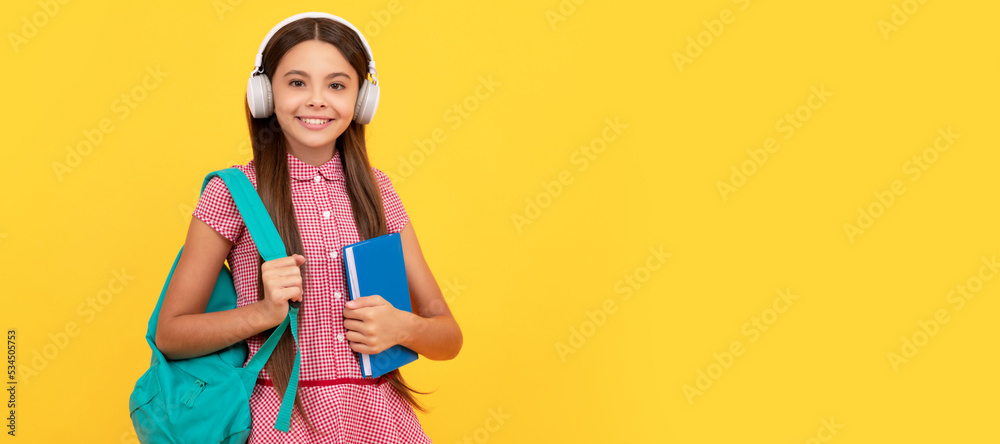 happy school teen girl in headphones carry backpack and workbook, elearning. Banner of school girl student. Schoolgirl pupil portrait with copy space. happy school teen girl in headphones carry backpack and workbook, elearning. Banner of school girl student. Schoolgirl pupil portrait with copy space.