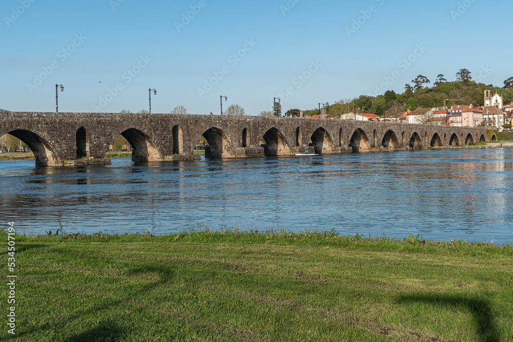 Fototapeta premium Roman bridge in Ponte de Lima, Oldest city in Portugal. It is named for a long medieval bridge that runs across the Lima River.