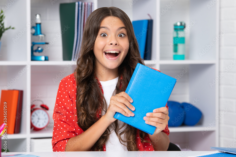 Teenager school girl hold book ready to learn. Excited face, cheerful emotions of teenager girl. Teenager school girl hold book ready to learn. Excited face, cheerful emotions of teenager girl.