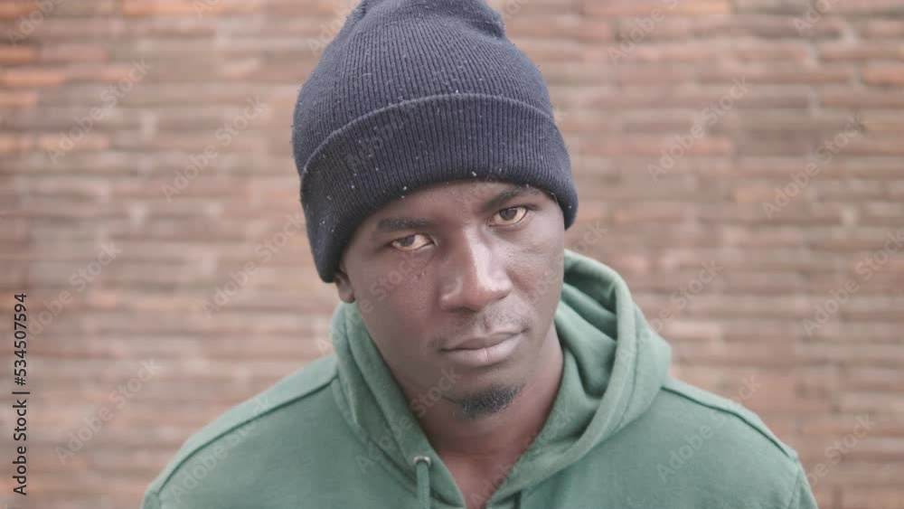 Close up on sad serious african migrant: despair, fear, sadness Close up on sad serious african migrant: despair, fear, sadness
