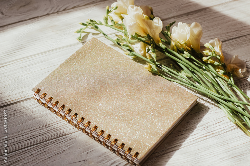 Diary notebook on the background of flowers and wooden figured boards. Diary notebook on the background of flowers and wooden figured boards.