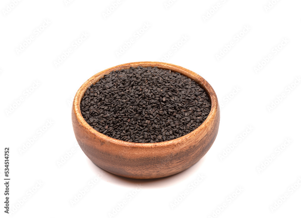 Sesame seeds in a wooden bowl over white background. Sesame seeds in a wooden bowl over white background.