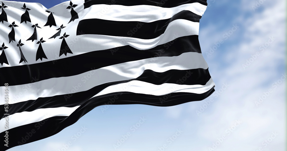 View of the Brittany flag waving in the wind on a clear day - obrazy, fototapety, plakaty 