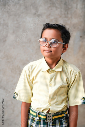 Indian school boy giving thinking gesture.