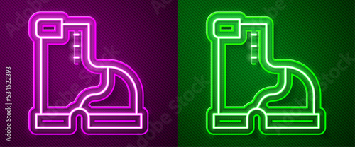 Glowing neon line Winter warm boot icon isolated on purple and green background. Waterproof rubber boot. Vector