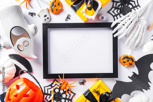 Happy Halloween holiday greeting card background. Flat lay gift boxes, set of Halloween symbols- spiders, bats, pumpkin, party decorations on white background