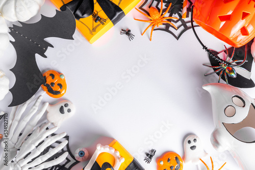 Happy Halloween holiday greeting card background. Flat lay gift boxes, set of Halloween symbols- spiders, bats, pumpkin, party decorations on white background
