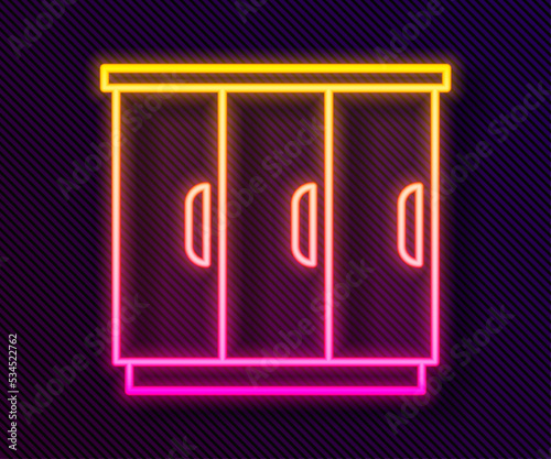 Glowing neon line Wardrobe icon isolated on black background. Cupboard sign. Vector