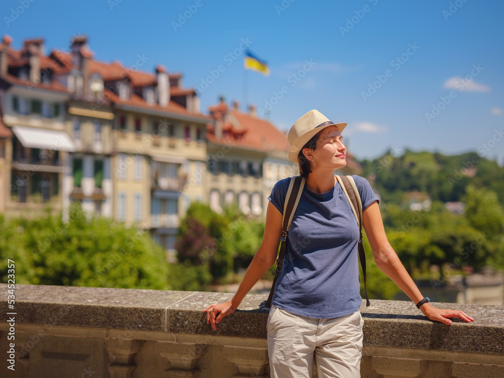 having great vacation in Switzerland, BErn. Lady visiting tourist attractions and landmarks. Woman tourist on top of cityscape view to old town of Bern