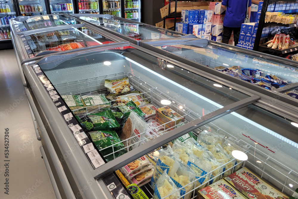 Penang, Malaysia 24 SEP 2022 Huge fridge with various choice frozen foods in a grocery store