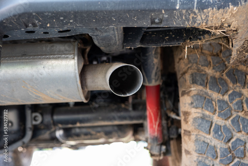 SUV car exhaust muffler or resonator and tip. Low angle view, no people photo
