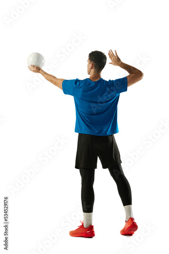 Back view of professional volleyball player in sports uniform training with ball isolated on white background. Action, healthy lifestyle, team sport © master1305