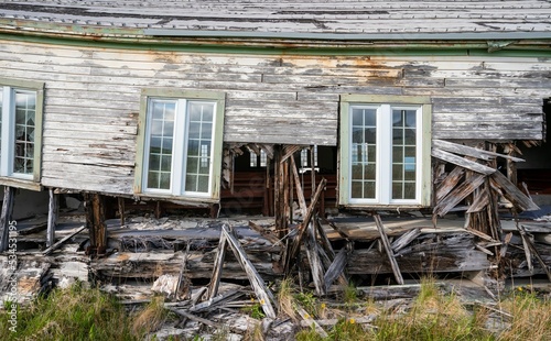 Decaying facade and windows of the historic Bering Hill Chapel on Adak Island photo