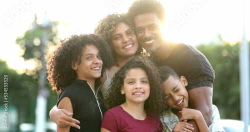 Happy beautiful African Brazilian family outside smiling