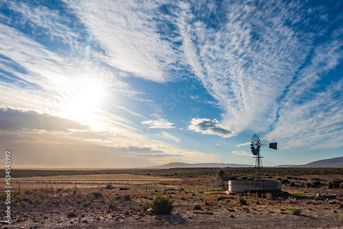 Image Number ZV1452054. Windmill (windpump) in a Roggeveld rural scene showing beautiful cloud formations. Near Sutherland, Northern Cape. South Africa. photo