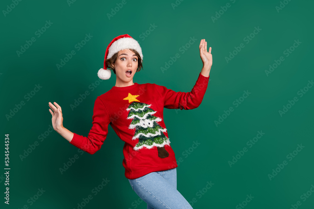Photo of shocked pretty person raise arms open mouth sneaky walk isolated on green color background Photo of shocked pretty person raise arms open mouth sneaky walk isolated on green color background
