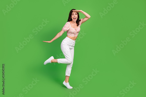 Full body size photo of young attractive nice cute girl wear summer outfit dreamy look far away positive crazy empty space isolated on green color background