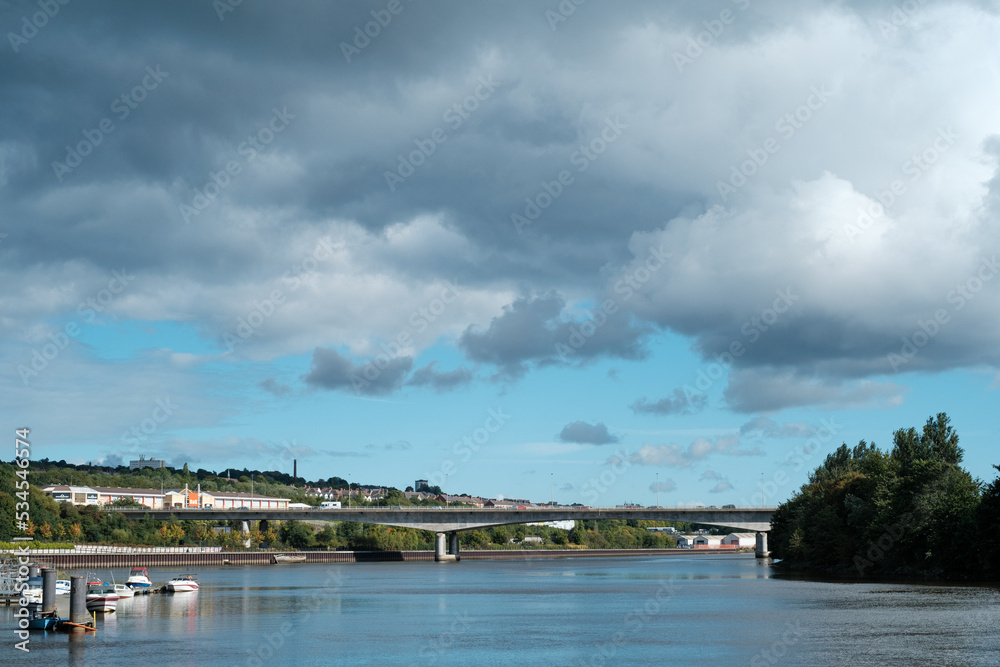 Newcastle UK: 24th Sept 2022 Newburn Riverside at the River Tyne on Hadrians Cycleway - Route 72.  Waves on a windy day with the A1 motorway bridge and BandQ in the background
