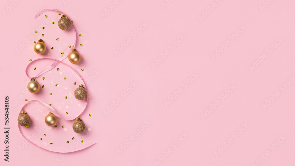 Christmas card with golden glitter balls, confetti in the form of heart and satin ribbon on pink background with copy space Christmas card with golden glitter balls, confetti in the form of heart and satin ribbon on pink background with copy space