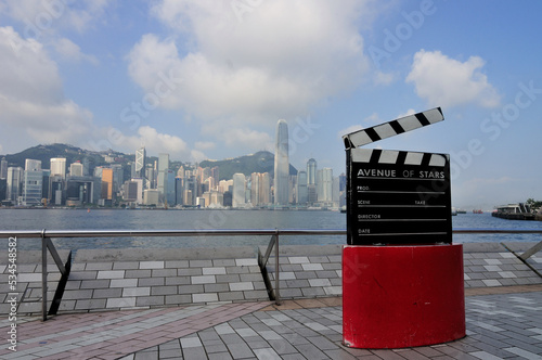 Film Clapboard Monument At Avenue Of Stars with background skyline view of business district In Hong Kong.