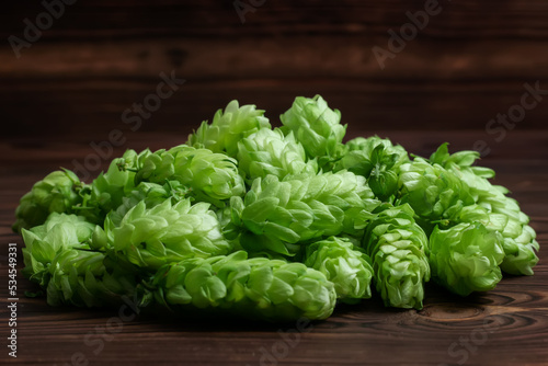 Pile fresh green hops on a wooden table. close up