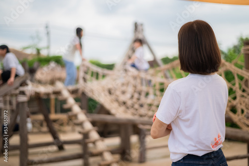 Fototapeta Naklejka Na Ścianę i Meble -  Asian woman happy teacher standing on  playground background