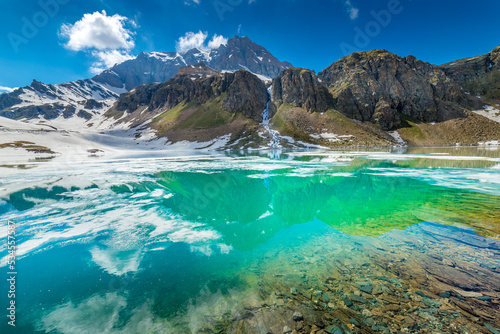Fototapeta Naklejka Na Ścianę i Meble -  Alpine emerald lake and mountains at springtime, Gran Paradiso Alps, Italy