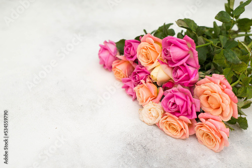 a bouquet of pink roses on a gray background.