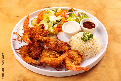 Tablou pe pânză Fried shrimp breaded with coconut, sweet sauce, salad and rice, food, gastronomy