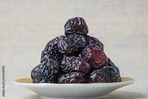 Delicious ajwa dates ( kurma nabi ), Much sought after during the month of Ramadan as a dish for breaking the fast, ramadhan kareem, empty space, copy space. photo