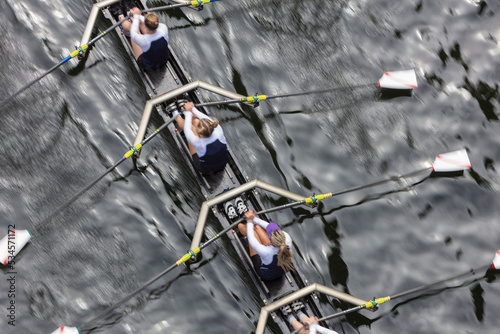 Overhead view of female crew racers rowing in an octuple racing shell, an eights team. photo