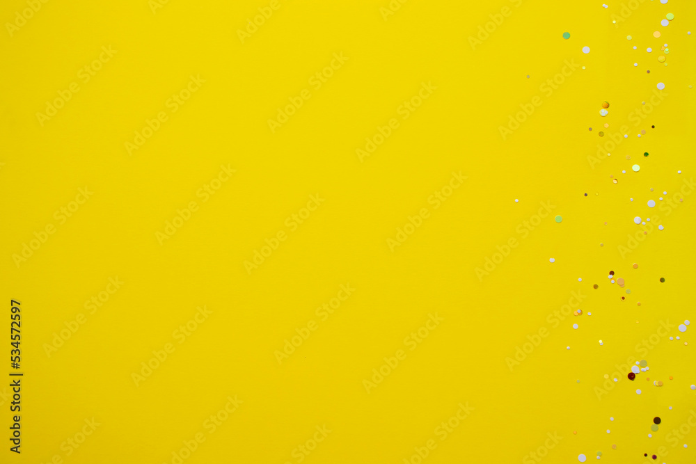 Yellow background with glitter. Copy space for text. Flat lay, top view, copy space. Design for text.