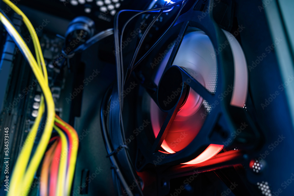 Glowing computer cooler while working close-up. Inside the computer. Glowing computer cooler while working close-up. Inside the computer.