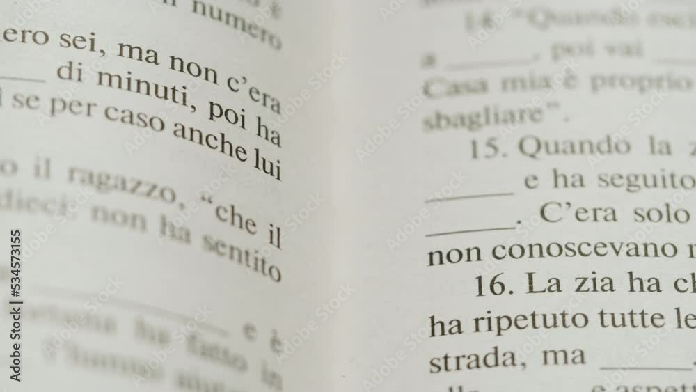 Flipping Spanish language book pages, reading and education, Flicking Through Old textbook Close-up, macro shot of paper in university library. Flipping Spanish language book pages, reading and education, Flicking Through Old textbook Close-up, macro shot of paper in university library.