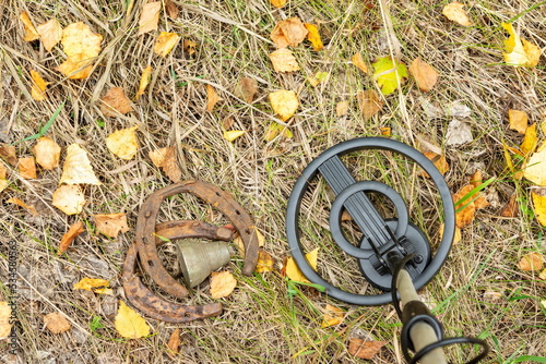 Old horseshoes, collected with a metal detector, against the background of an autumn forest.