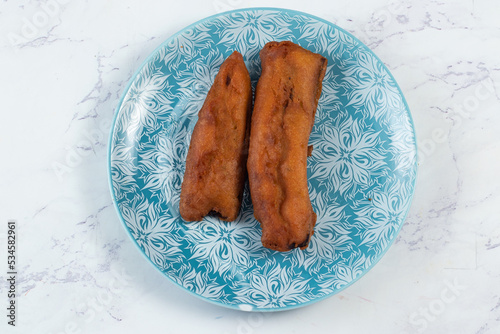deep fried brinjal pakora or beguni served in a dish isolated on background top view of Indian and bengali food photo