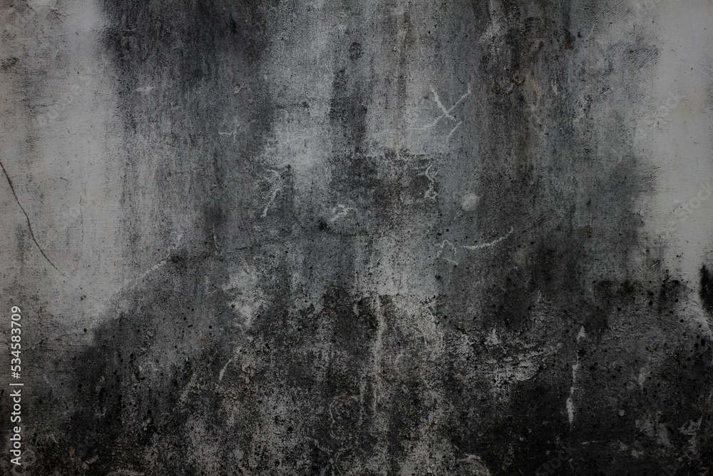 Dark background wall for vintage design. Cracks on the gray concrete surface, cracked old walls