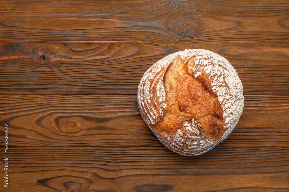 Homemade freshly baked bread. Wood rustic table, board. Rural food cooking. Top view Homemade freshly baked bread. Wood rustic table, board. Rural food cooking. Top view