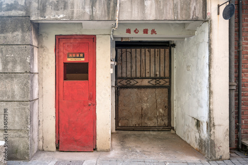 old red door in a wall © youm