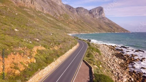 Road running along a coastline, between mountain and sea photo