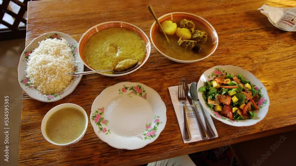 A set of dishes on the table - rice, salad, stew and soup, rustic asian or arabian set of dishes. A set of dishes on the table - rice, salad, stew and soup, rustic asian or arabian set of dishes.