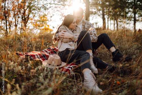 Happy couple in love newlyweds in casual clothes travel together, hike and walk in the autumn forest in nature. © maxbelchenko