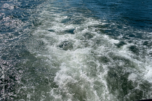 Powerful waves shot from a fast moving boat