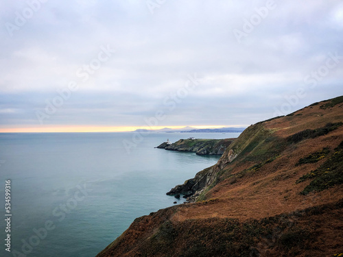 view of the coast of the north atlantic ocean at golden hour from the Howth cliff walk in Ireland in autumn