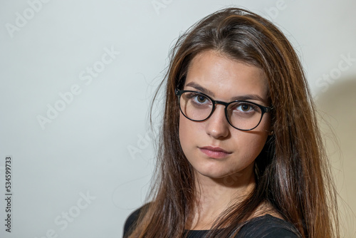 Portrait of beautiful young woman with glasses. Horizontally. 