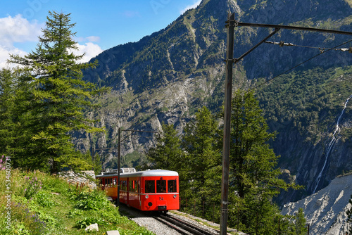A red tourist train on the rack railway towards the station of Montenvers at the Mer de Glace in summer, Chamonix-Mont-Blanc, Haute-Savoie, France