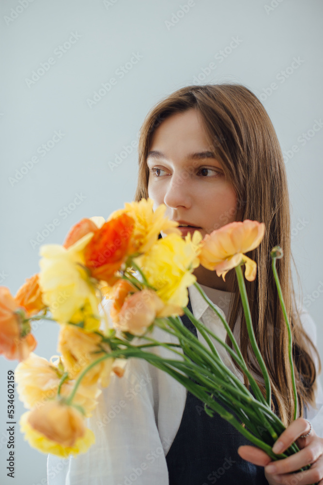 Portrait of a woman holding a bouquet of flowers - stock photo