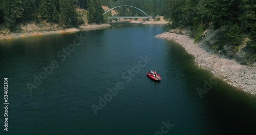 Sweeping drone shot of a bridge overlooking a lake. photo