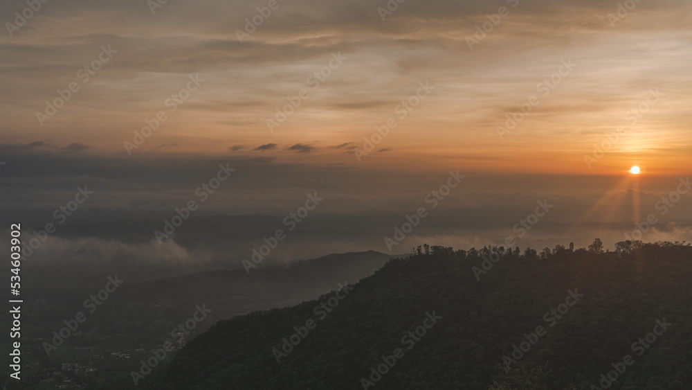 sunset over the mountains - sunrays on hills - scenic view of fog over mountains